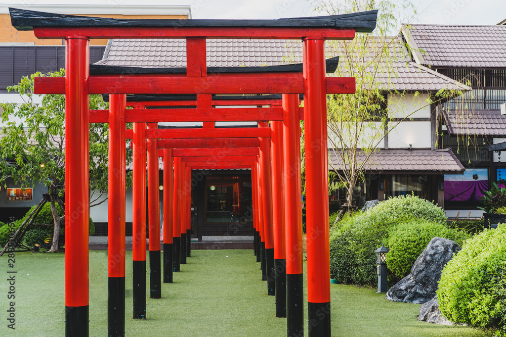Red and orange tori tunnel in Fushimi Inari Shrine in Thailand with japan style gate. It is one of the most famous place for tourist. Red and orange tori tunnel in Fushimi Inari Shrine in Thailand with japan style gate. It is one of the most famous place for tourist.