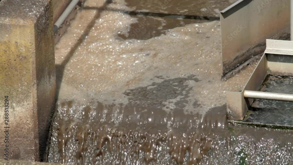 Close up shot of bubbeling waster water in a small local waste water treatment facility for organic pre-cleaning of sewage waters. Close up shot of bubbeling waster water in a small local waste water treatment facility for organic pre-cleaning of sewage waters.