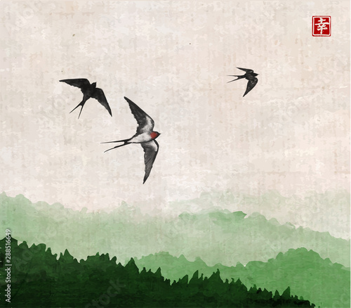 Swallow birds flying over the forest. Traditional Japanese ink wash painting sumi-e on vintage background. Hieroglyph - happiness.