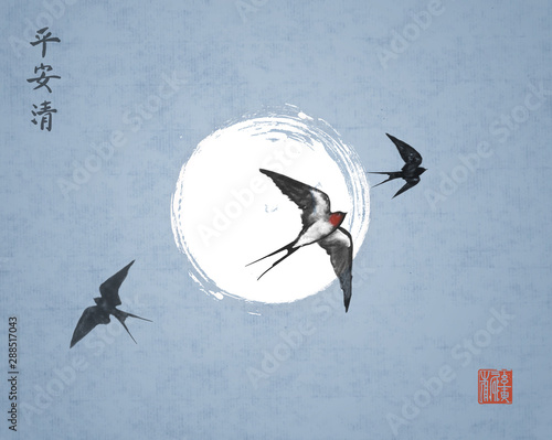 Three swallow birds on night sky background. Traditional Japanese ink wash painting sumi-e with swallows and the moon. Hieroglyphs - peace, tranquility, clarity.