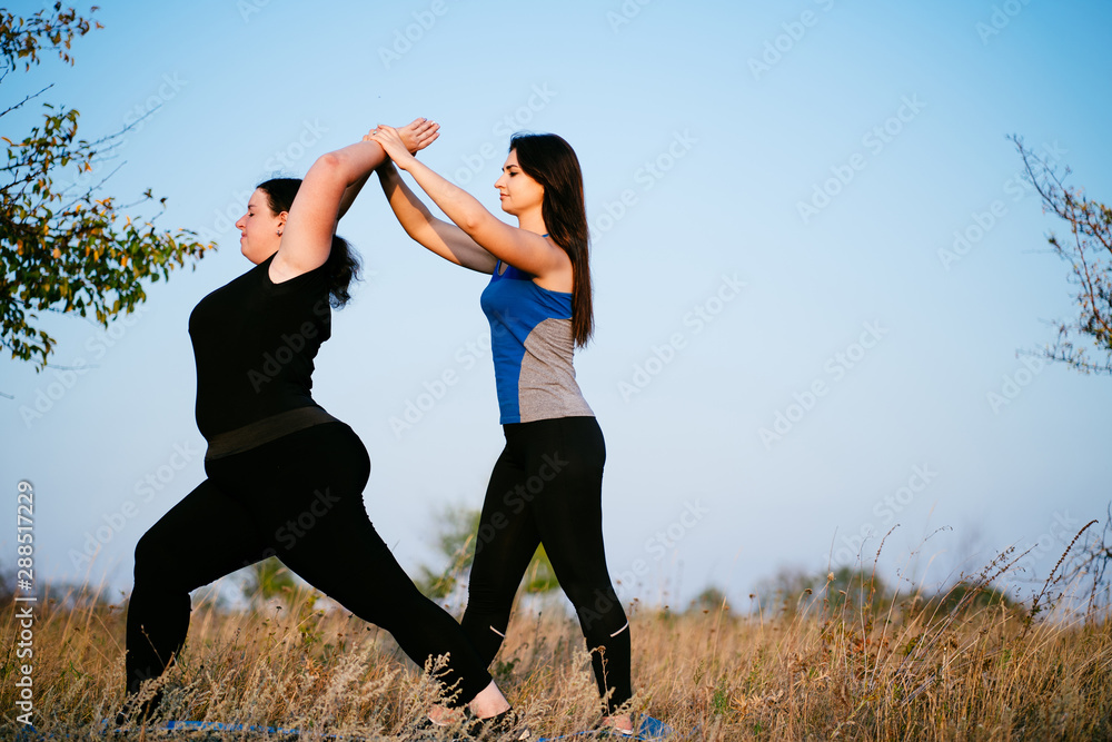Overweight woman working out with personal trainer Overweight woman working out with personal trainer