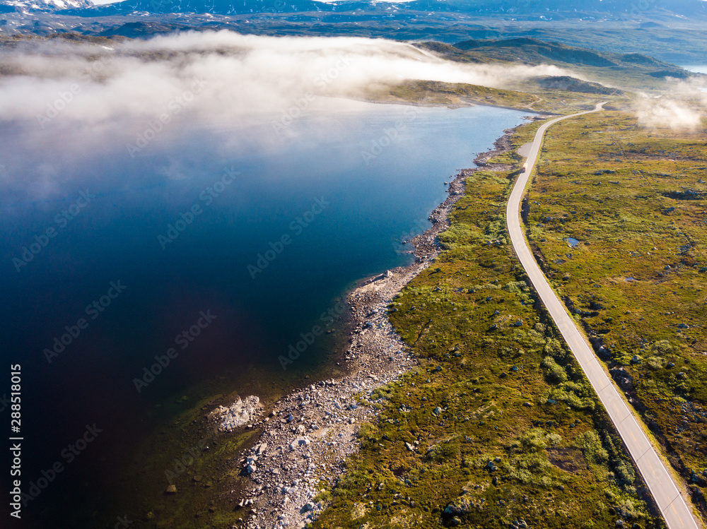 Fototapeta premium Road crossing Hardangervidda plateau, Norway. Aerial view.