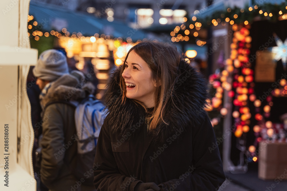 Woman buying gifts in a Christmas market Woman buying gifts in a Christmas market
