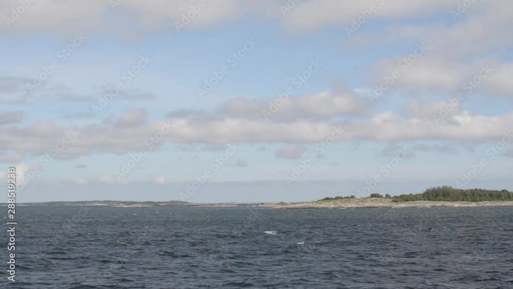 An accelerated view from a ship with small islands going by in the horizon on a sunny day in the arhipelago of Turku. An accelerated view from a ship with small islands going by in the horizon on a sunny day in the arhipelago of Turku.