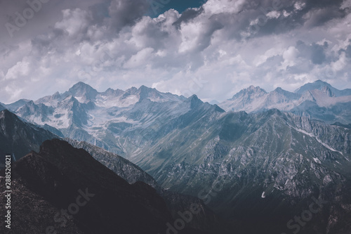 Mountains scene with dramatic cloudy sky in national park of Dombay
