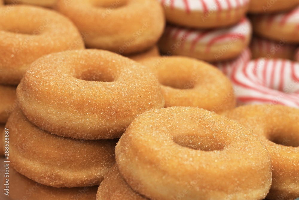 Round sugar donuts, cooked homemade, sweet dessert with sugar. Donuts background, copy space, place for text.