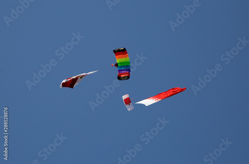 Parachute display team performs  during cricket festival at Isa Town, Bahrain photo