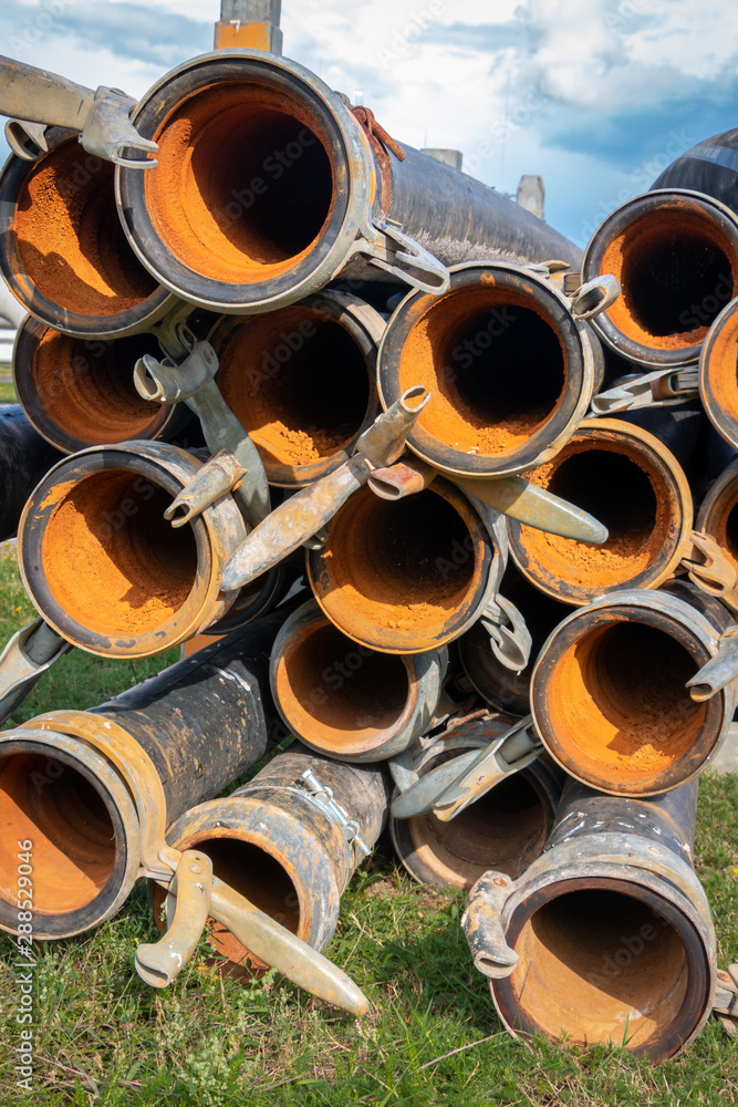 source drainage tubes piled up and normally in use for transportation of ground water to make sure the working well stays dry source drainage tubes piled up and normally in use for transportation of ground water to make sure the working well stays dry