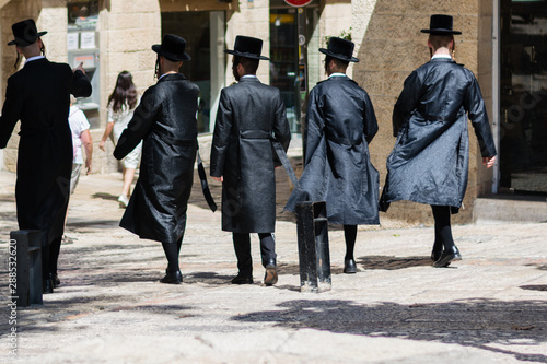 A group of Ultra Orthodox Jews walking on the street of the Old city of Jerusalem