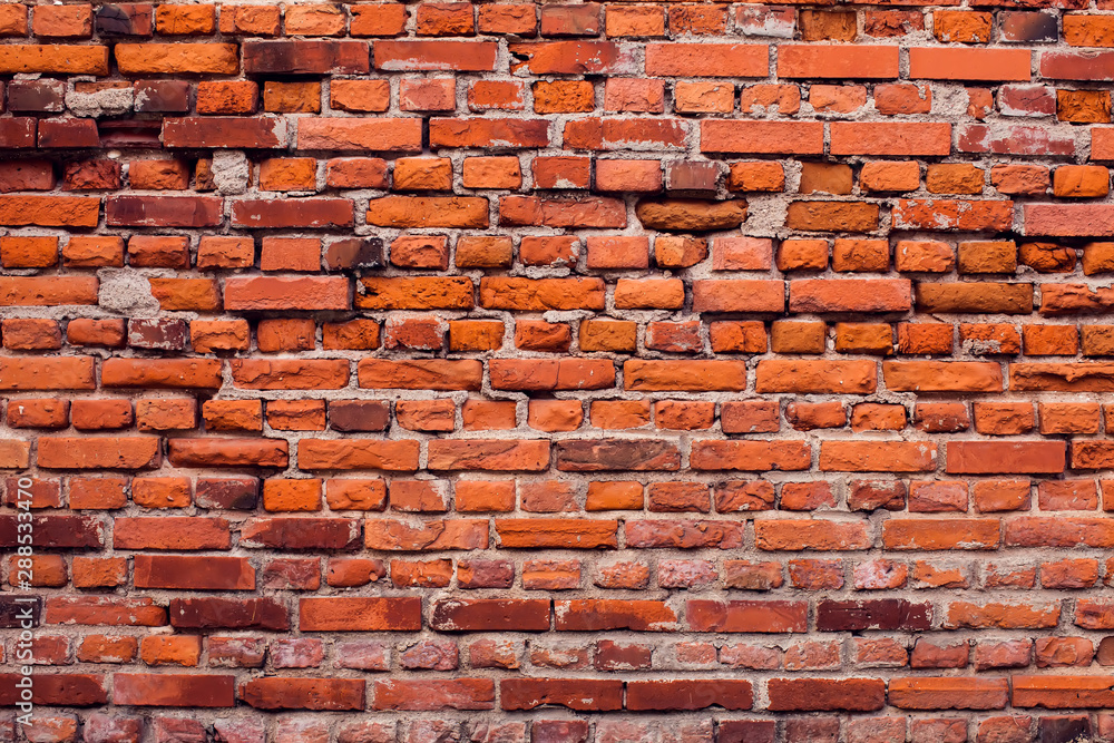 Naklejka premium Red bricks wall background. Old building surface
