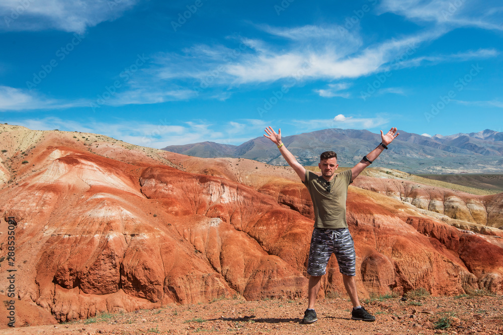 Fototapeta premium Happy man in Valley of Mars landscapes in the Altai Mountains, Kyzyl Chin, Siberia, Russia