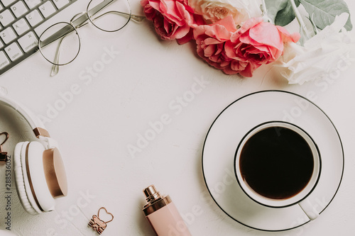 Office desk with computer and rose flowers