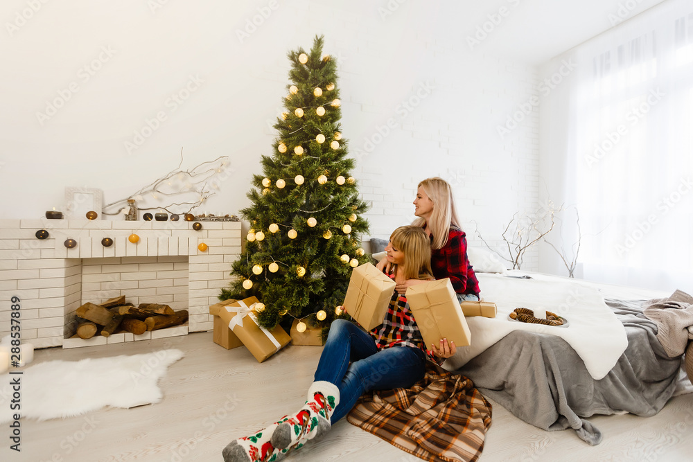 Two girlfriends exchanging christmas presents Two girlfriends exchanging christmas presents