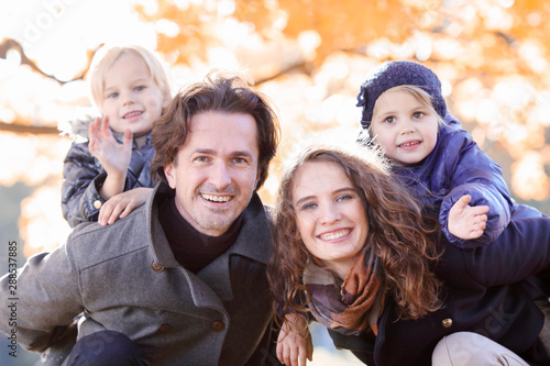 Family hug in autumn park