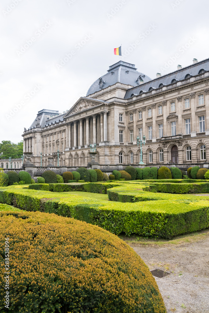 close up of front of royal palace in brussels belgium with garden hedges