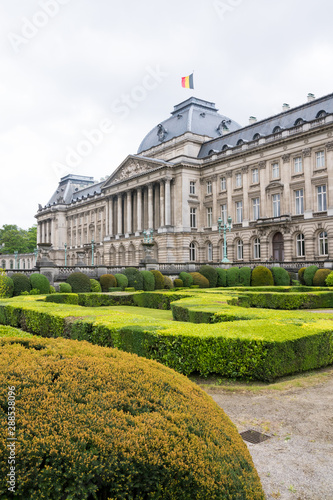 close up of front of royal palace in brussels belgium with garden hedges