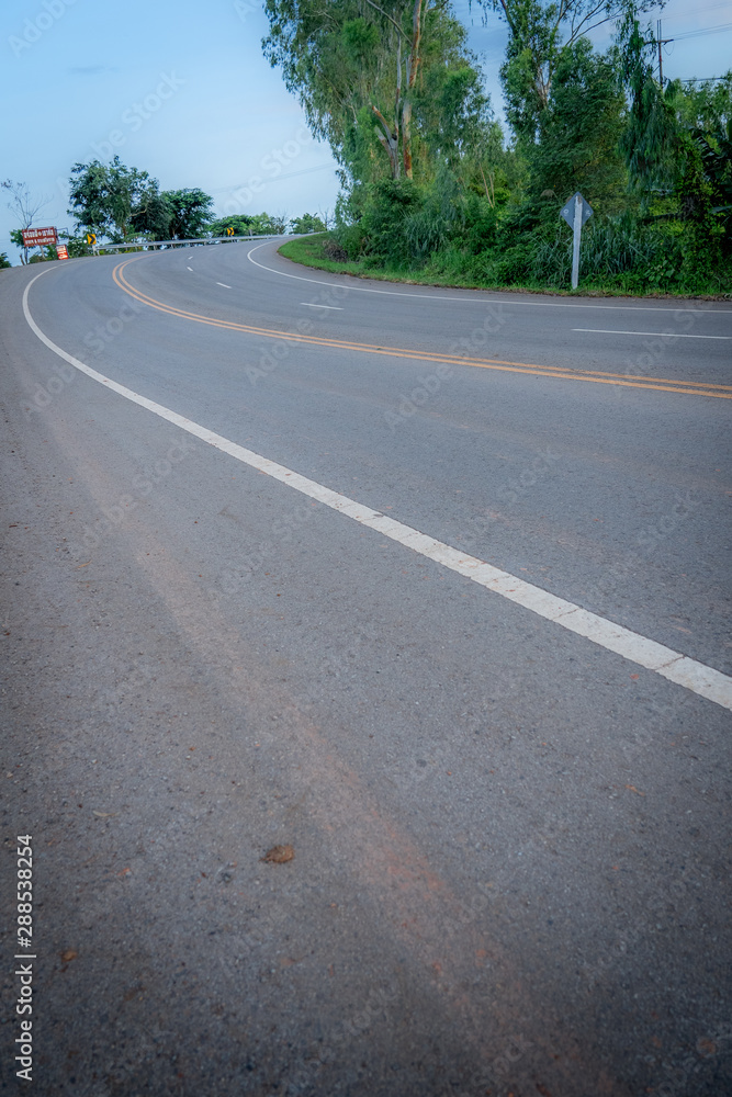 Fototapeta premium Long empty rural highway road beautiful summer day, Khao Kho Phetchabun Province, THAILAND 