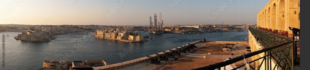 Valletta, Malta, August 2019. A panorama of the gun battery and a view of the three cities.
