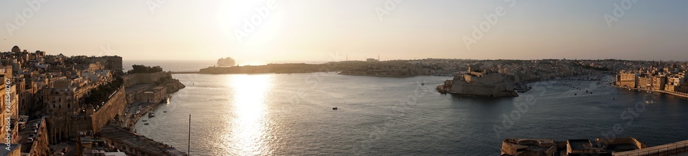 Valletta, Malta, August 2019. Panorama of sunrise over the Grand Harbor of the island`s capital. Valletta, Malta, August 2019. Panorama of sunrise over the Grand Harbor of the island`s capital.