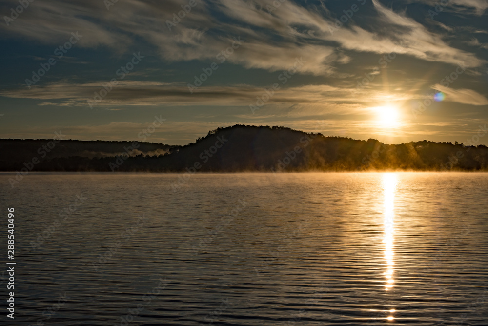 Fototapeta premium Sunrise over a Foggy Lake