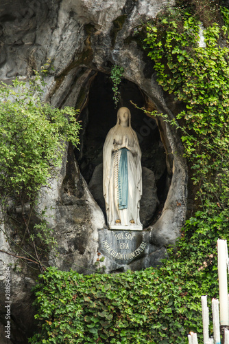Canvas Print Statue of Our Lady of Immaculate Conception with a rosary in the Grotto of Massa