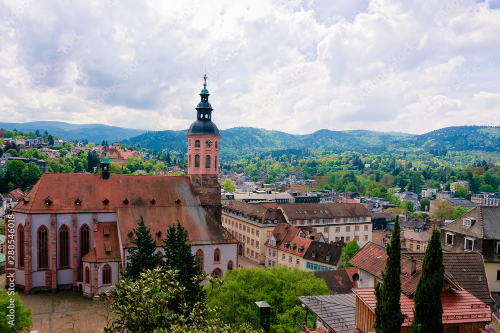 Stiftskirche Collegiate church and cityscape with Black forest in Old city of Baden Baden in Baden Wurttemberg region of Germany. Panoramic view of Bath and spa German town in Europe. Landmark
