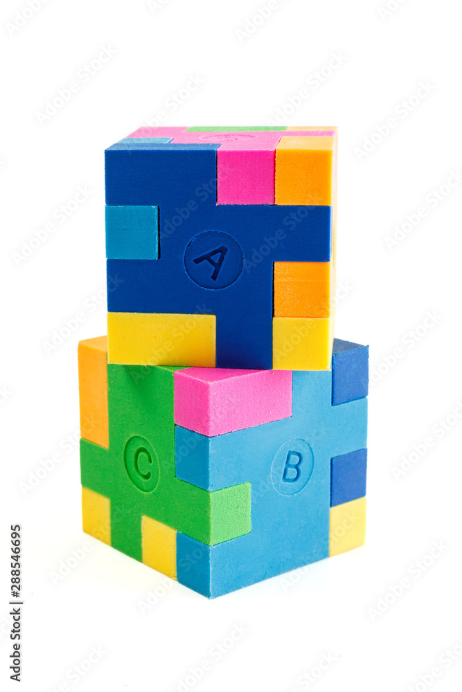 Two cube puzzle of multi-colored rubber shapes. Concept of decision making process, creative, logical thinking. Logical tasks. Two cube puzzle of multi-colored rubber shapes. Concept of decision making process, creative, logical thinking. Logical tasks.