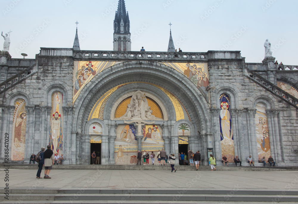 Lourdes, France, 24 June 2019: Front of the richly decorated entrance to the Rosary Basilica in Lourdest