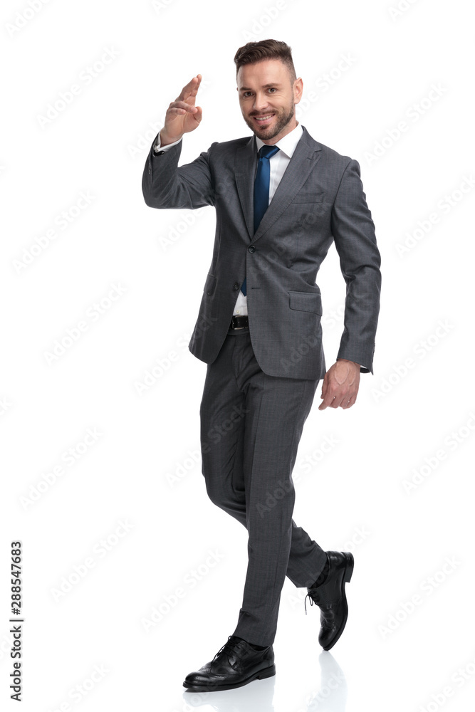 happy young businessman giving a military salute while walking happy young businessman giving a military salute while walking