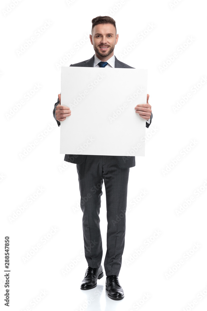 smiling young businessman showing a blank board smiling young businessman showing a blank board