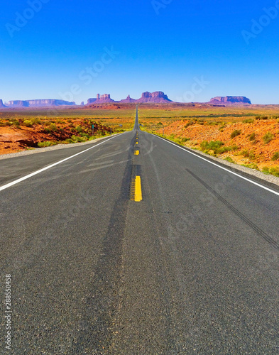 View of Monument Valley on a sunny day near the border of Arizona and Utah in Navajo Nation Reservation in USA.
