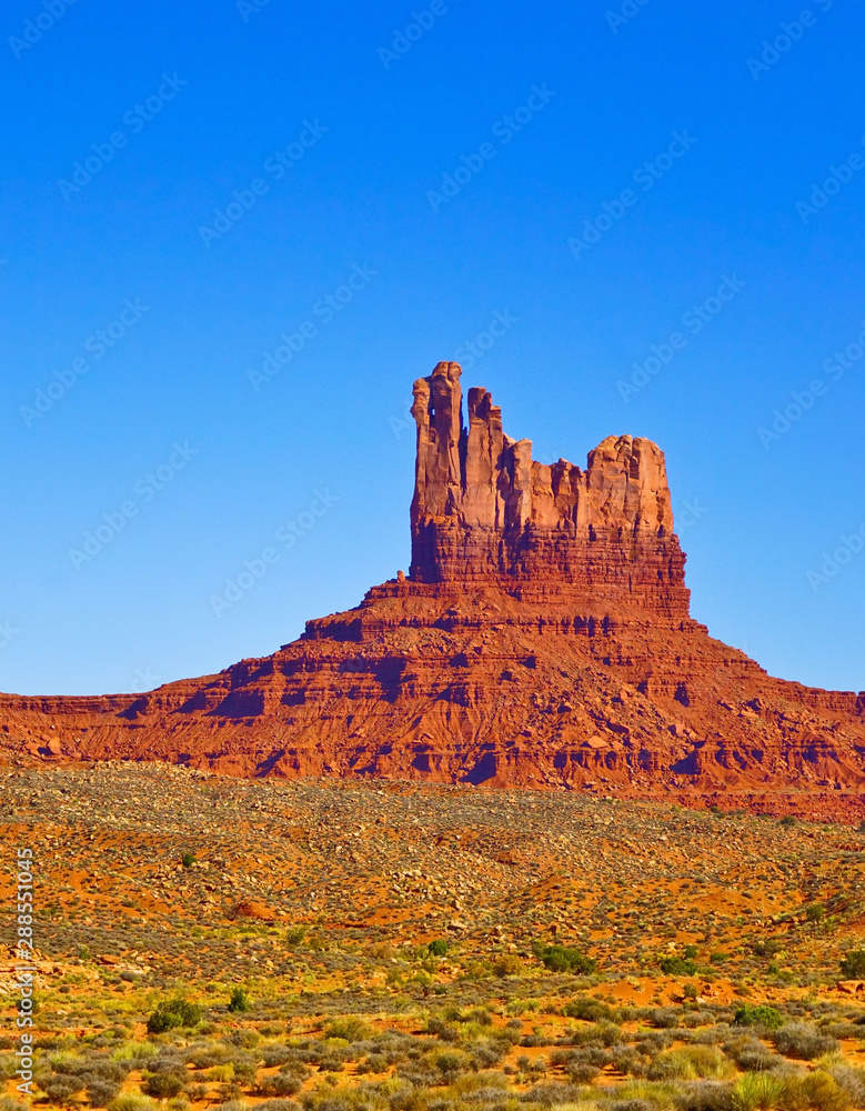 View of Monument Valley on a sunny day on the Highway 163 in Navajo Nation Reservation in USA. View of Monument Valley on a sunny day on the Highway 163 in Navajo Nation Reservation in USA.