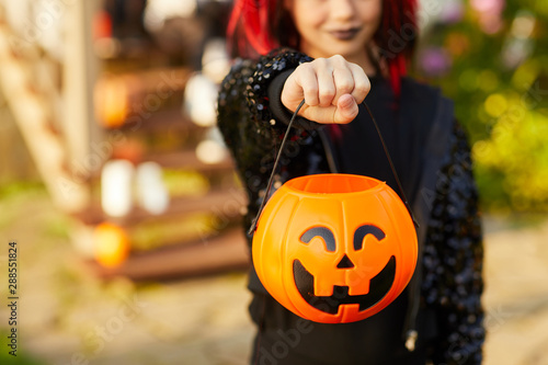 Canvas Print Closeup of unrecognizable little girl wearing Halloween costume and holding pump