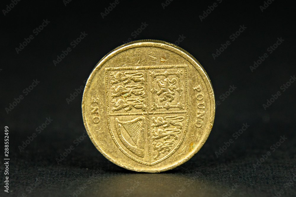 Old British one pound coin on a black background Old British one pound coin on a black background