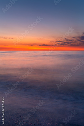 Colourful sky over the north sea after sunset at the beach on Juist, East Frisian Islands, Germany.