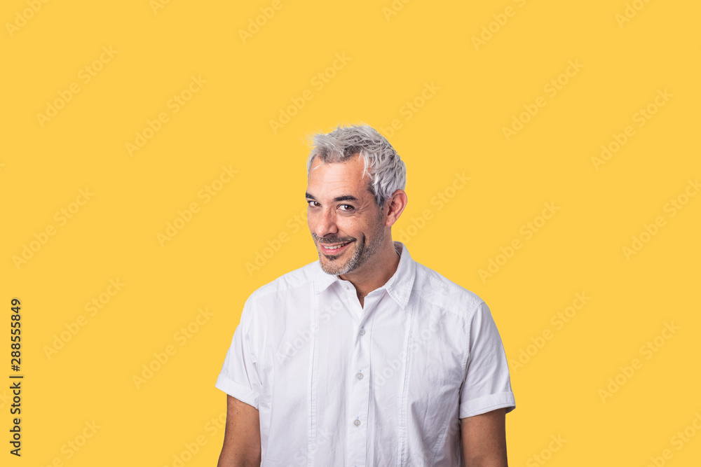 Concept of human facial expressions. A Hispanic man with an attractive, true, daring, mischievous look.on a background-colored wall. Concept of human facial expressions. A Hispanic man with an attractive, true, daring, mischievous look.on a background-colored wall.