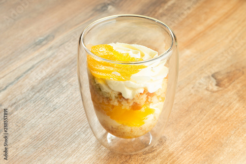 Delicious trifle dessert in glasses. Dessert with whipped cream, fruit, mango. Sweets after lunch. Food photo for recipe or menu