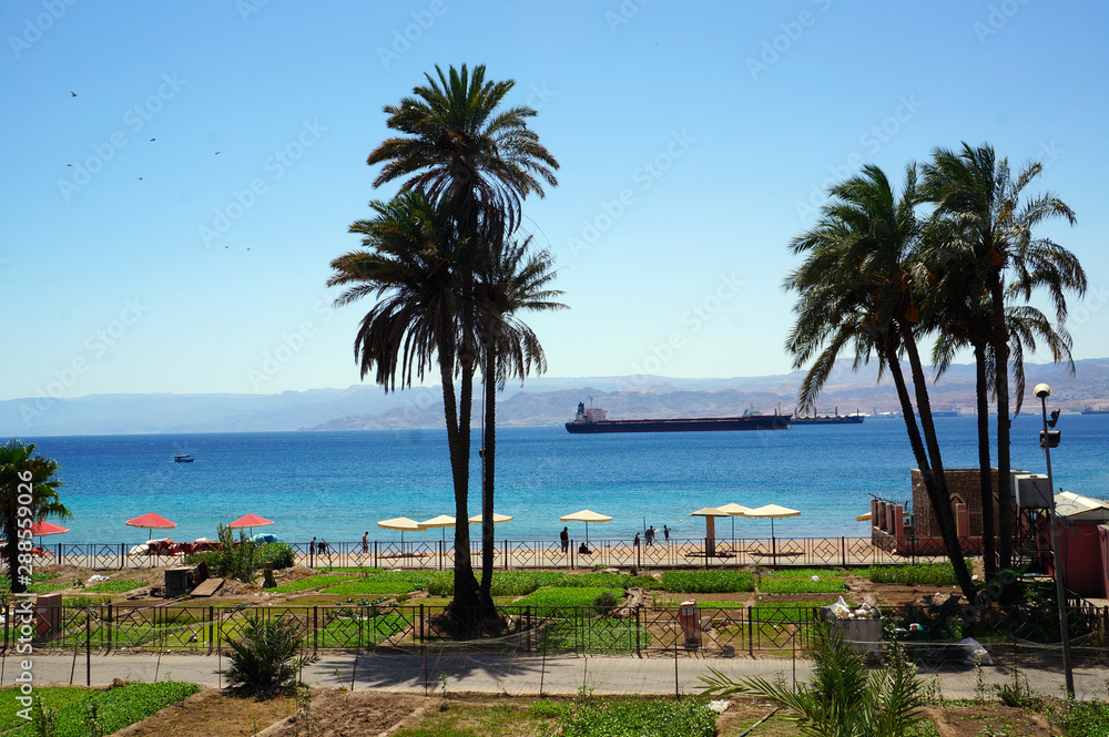 Aqaba waterfront with cargo ship moored in the distance