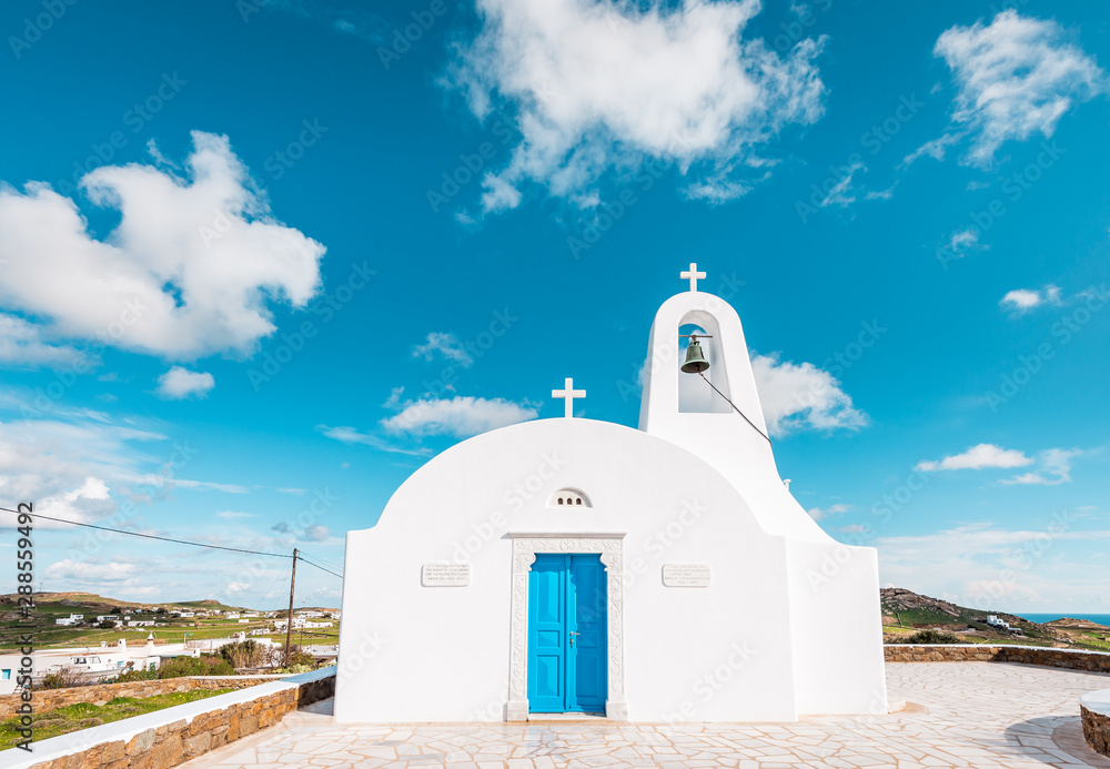 White little chapel, Greek church on Mykonos Island with blue door, Cyclades, Greece