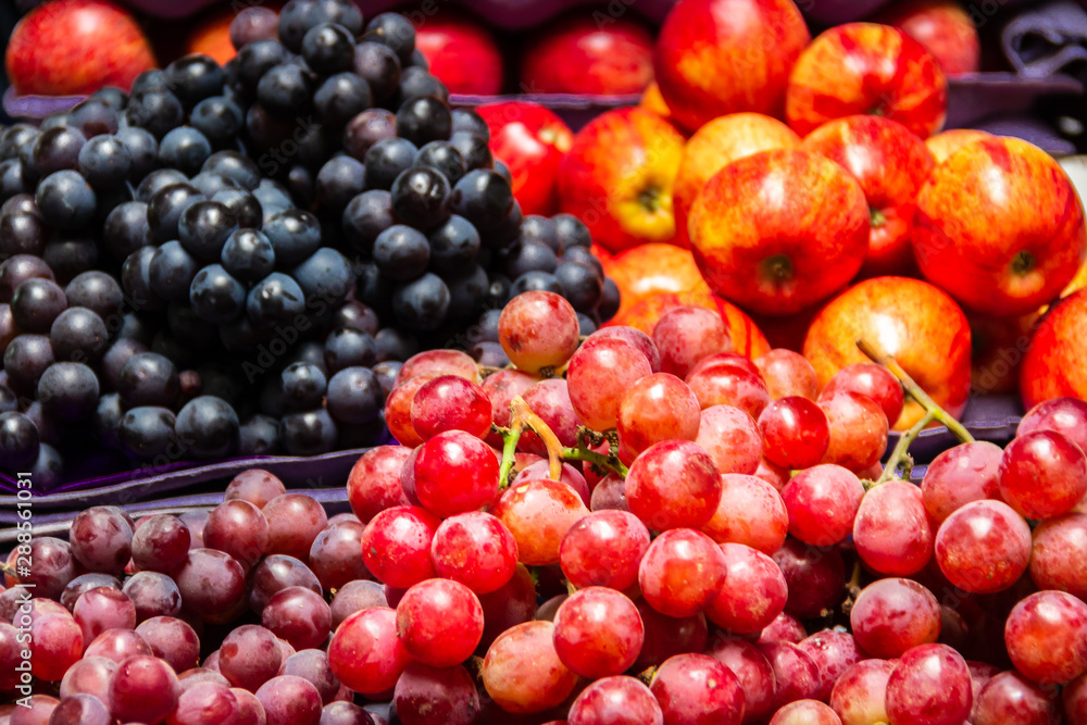 Quito, Ecuador - Red and Black Grapes and Apples at a Market in Quito Quito, Ecuador - Red and Black Grapes and Apples at a Market in Quito