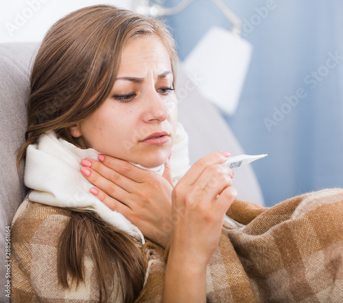 Ill girl measuring temperature photo