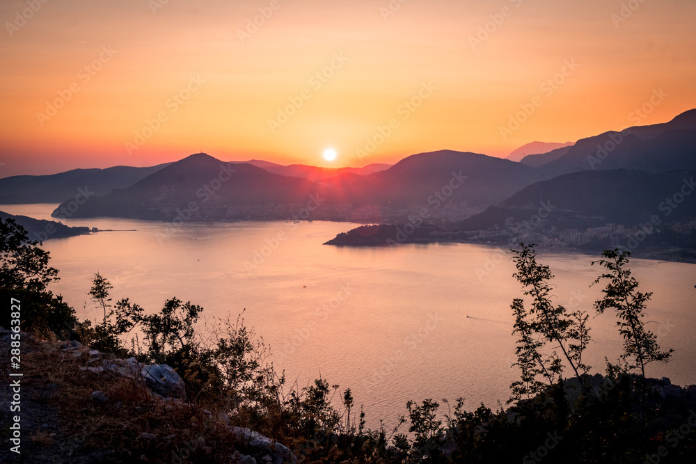 Sunset on the sea among the beautiful mountains, the Adriatic Sea. Montenegro.