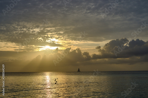 A sunset cruise on calm waters in a large catamaran sailboat off the coast of the Cayman Islands