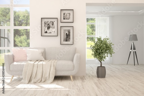 Stylish room in white color with sofa and summer landscape in window. Scandinavian interior design. 3D illustration