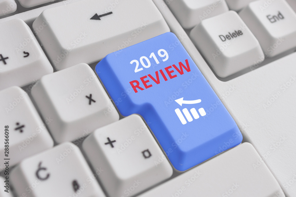 Conceptual hand writing showing 2019 Review. Concept meaning New trends and prospects in tourism or services for 2019 White pc keyboard with note paper above the white background Conceptual hand writing showing 2019 Review. Concept meaning New trends and prospects in tourism or services for 2019 White pc keyboard with note paper above the white background