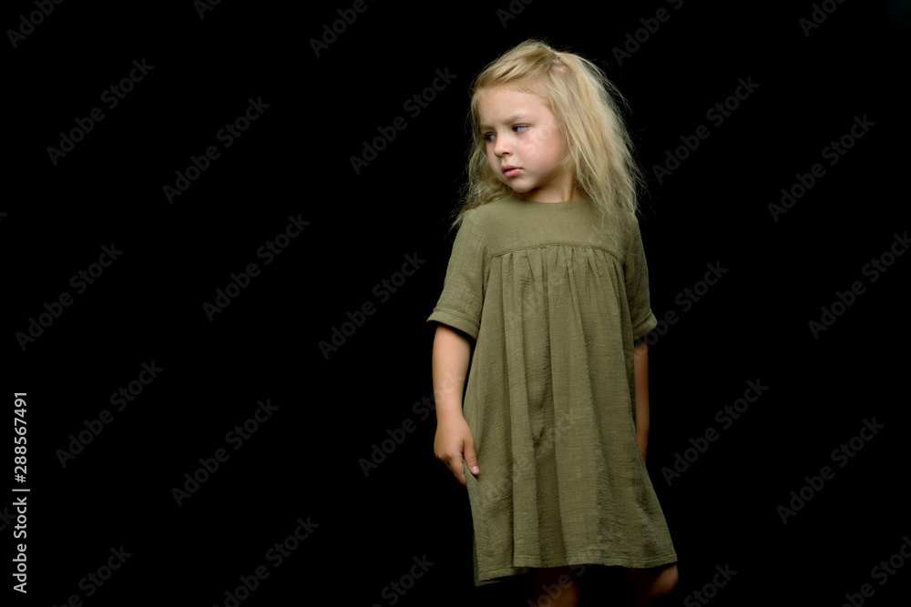 Portrait of a cute little girl on a black background. Happy chil Portrait of a cute little girl on a black background. Happy chil