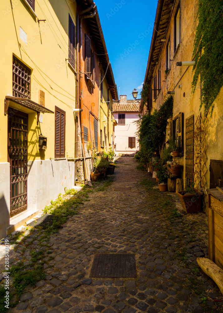 Picturesque street near the Piazza della Rocca (Fortress Square) on the Castle of Julius II. In Ostia Antica, Italy