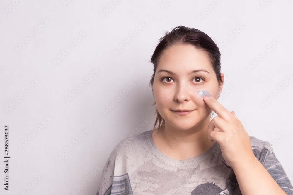 Portrait of spa woman receiving skin care treatment. Face mask. White background Portrait of spa woman receiving skin care treatment. Face mask. White background
