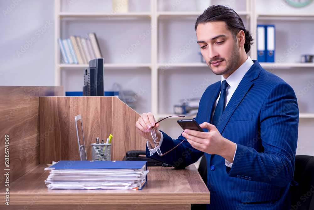 Young handsome businessman working in the office Young handsome businessman working in the office