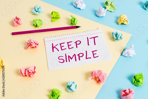 Text sign showing Keep It Simple. Business photo text to make something easy to understand and not in fancy way Colored crumpled papers empty reminder blue yellow background clothespin © Artur